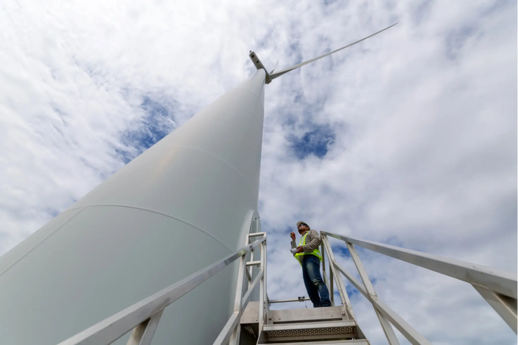 Technician at the entrance to a wind turbine